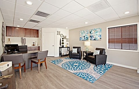 a living room and kitchen with a table and chairs